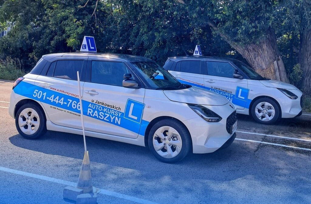 Two white cars parked next to each other.